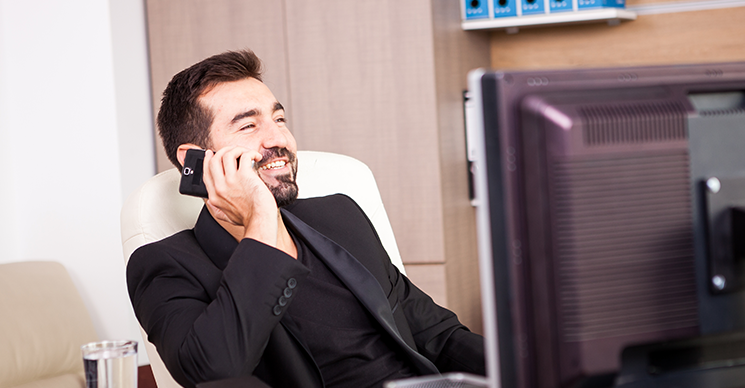 VoIP solutions displayed on smartphone and laptop beside traditional desk phone